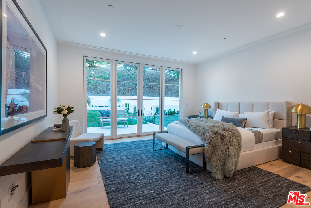 5716 Jed Smith Road Hidden Hills, CA 91302 - Photo 35 of 53 a bed room with bed and a large window