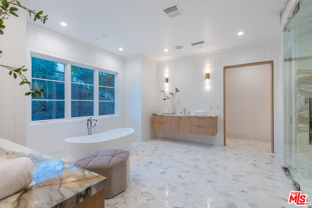 5716 Jed Smith Road Hidden Hills, CA 91302 - Photo 37 of 53 a bathroom with a tub sink and mirror