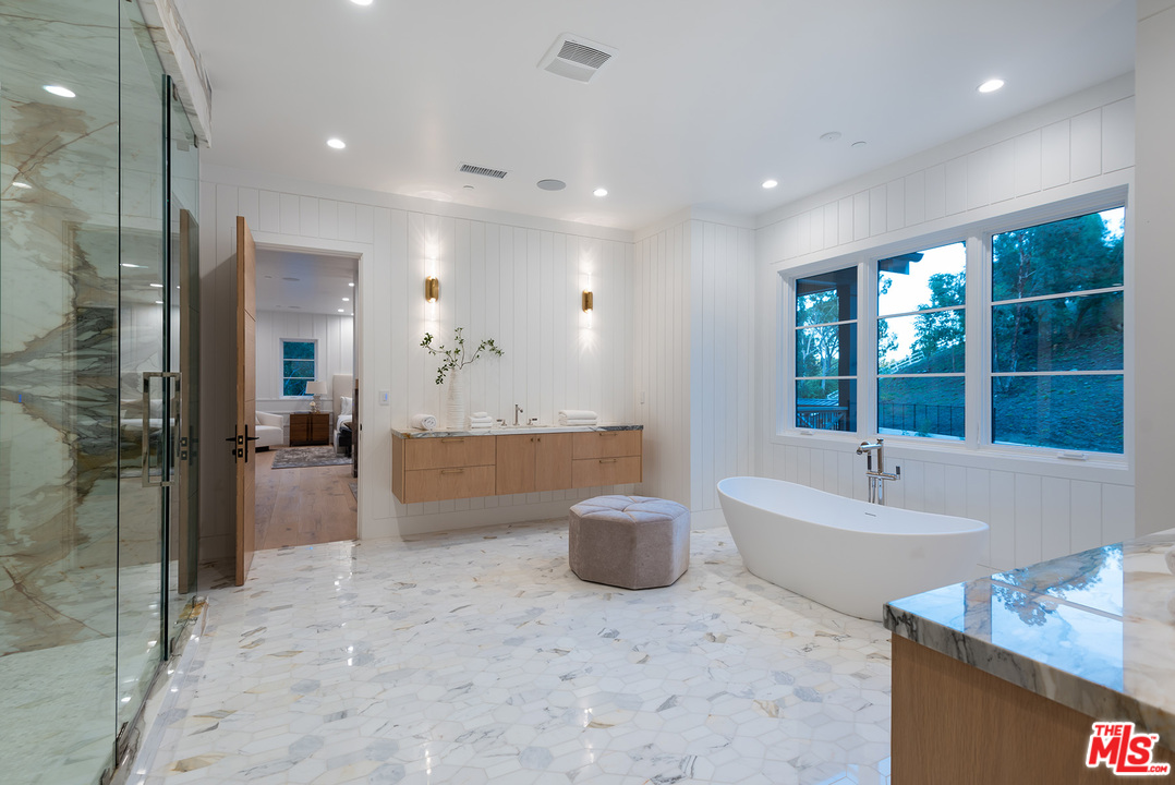 5716 Jed Smith Road Hidden Hills, CA 91302 - Photo 38 of 53 a bathroom with a tub sink and mirror