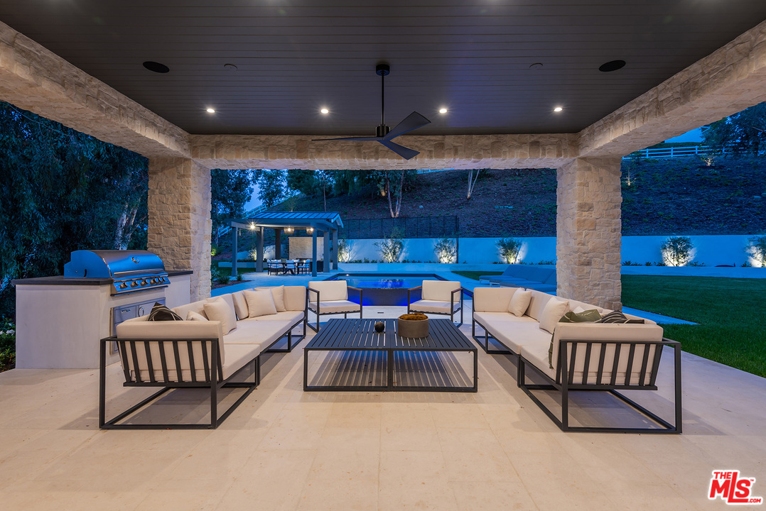 5716 Jed Smith Road Hidden Hills, CA 91302 - Photo 46 of 53 a living room with furniture and a fireplace