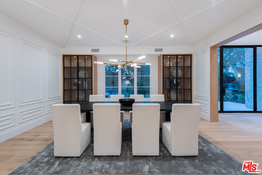 5716 Jed Smith Road Hidden Hills, CA 91302 - Photo 8 of 53 a living room with furniture a chandelier and a dining table