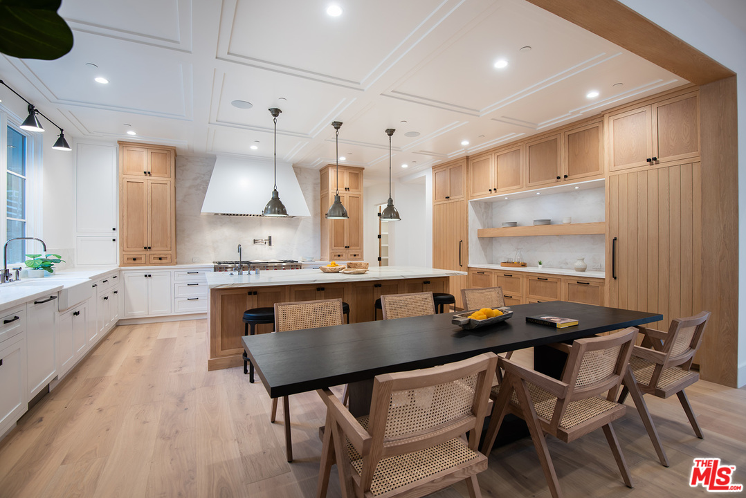 5716 Jed Smith Road Hidden Hills, CA 91302 - Photo 10 of 53 a kitchen with a table chairs stove and cabinets