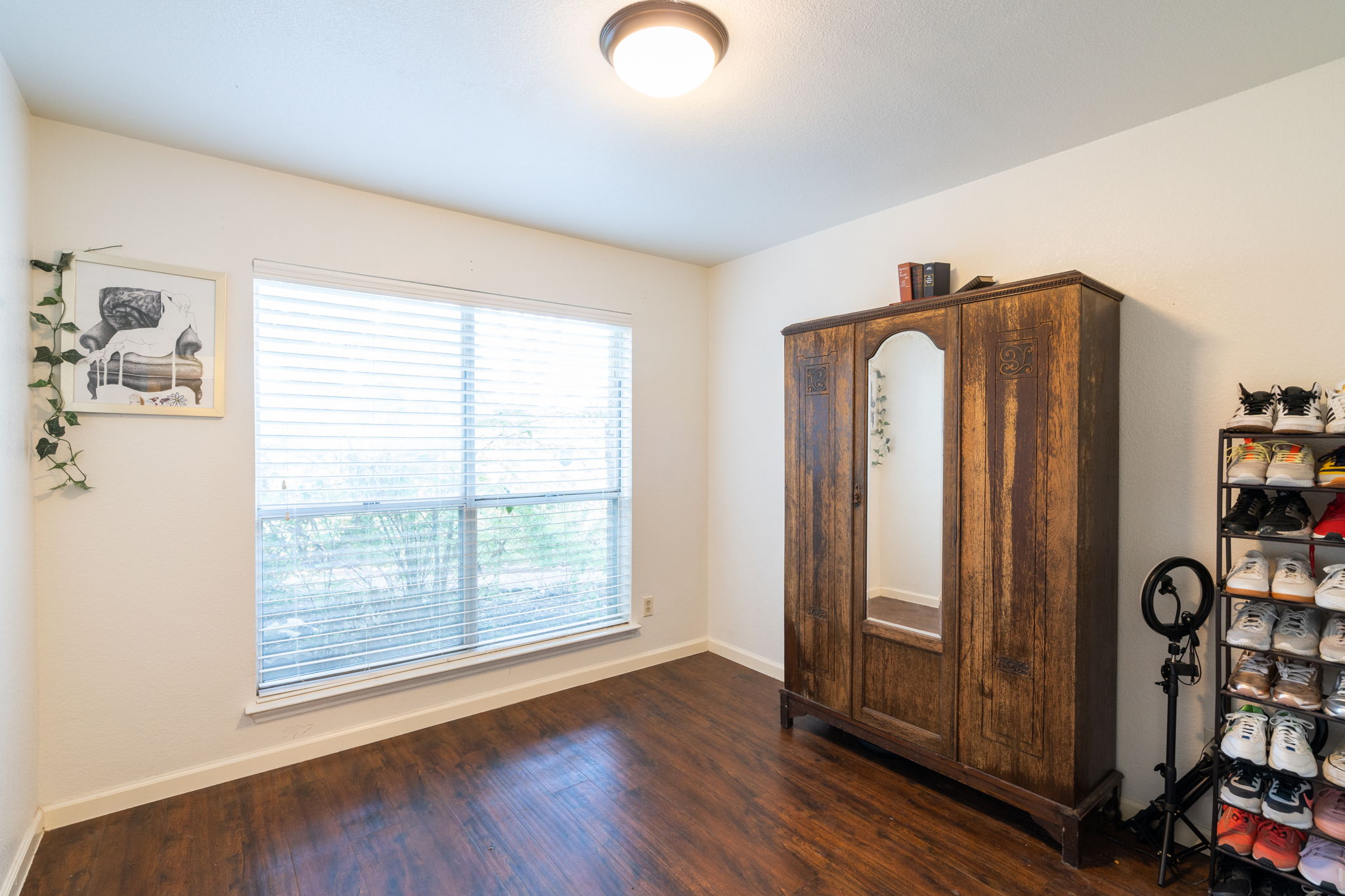 5611 Meadow Crest Austin, TX 78744 - Photo 21 of 29 Rich hardwood floors complement this cozy room with abundant natural light.
