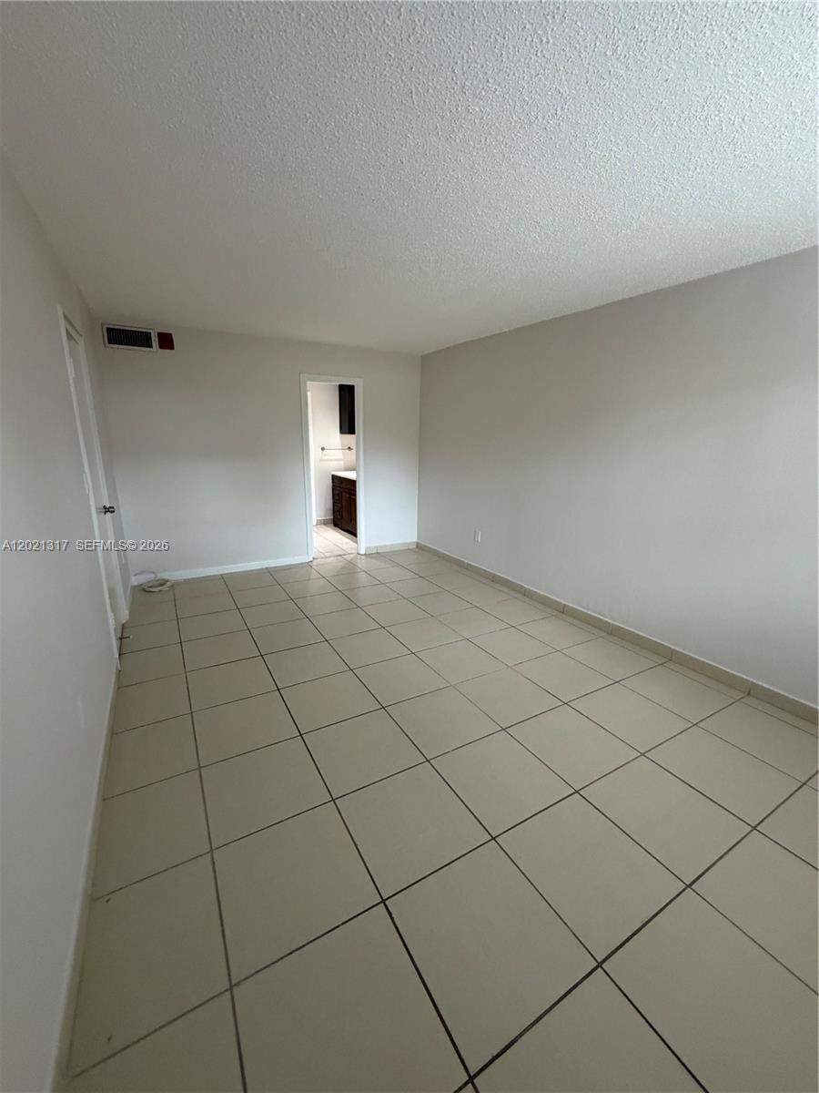 11201 Southwest 88th Street, Unit 102A Miami, FL 33173 - Photo 10 of 12 a view of an empty room and entryway