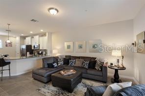 8653 Karpeal Drive, Unit 4 Sarasota, FL 34238 - Photo 2 of 14 a living room with furniture and a view of kitchen