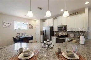a kitchen with sink refrigerator and microwave