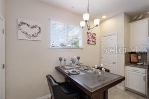 8653 Karpeal Drive, Unit 4 Sarasota, FL 34238 - Photo 5 of 14 a view of a dining room with furniture and chandelier