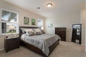 8653 Karpeal Drive, Unit 4 Sarasota, FL 34238 - Photo 6 of 14 a bedroom with a bed and a window