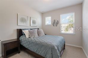 8653 Karpeal Drive, Unit 4 Sarasota, FL 34238 - Photo 9 of 14 a bedroom with a bed and window