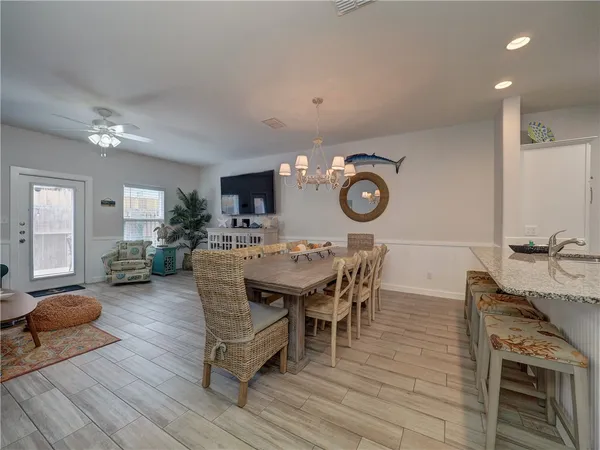 a view of a dining room with furniture and wooden floor