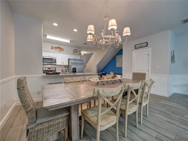 a view of a dining room with furniture and wooden floor