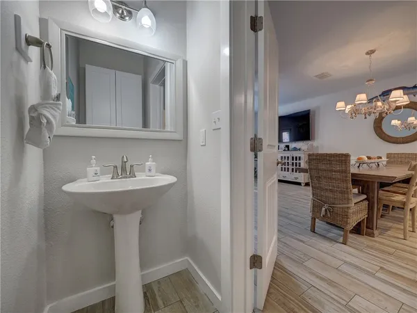 a bathroom with a sink a mirror and a window