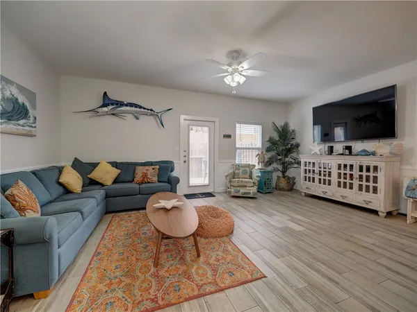 a living room with furniture and a flat screen tv