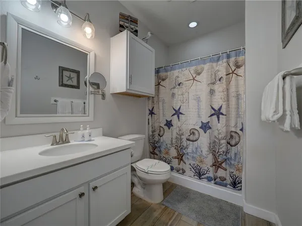 a bathroom with a sink toilet and shower