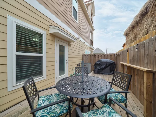 a view of a patio with a table and chairs