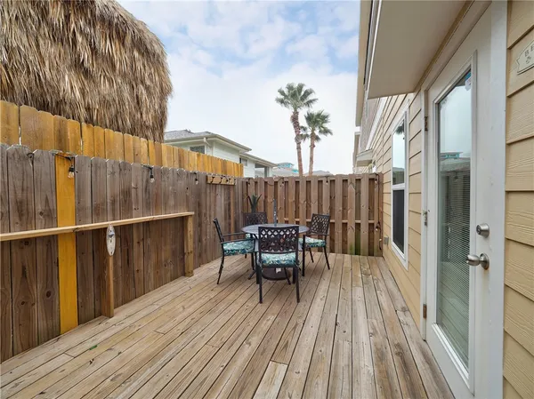a view of a balcony with chairs and wooden floor
