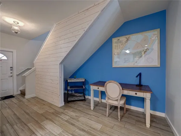 a workspace with furniture and a wooden floor