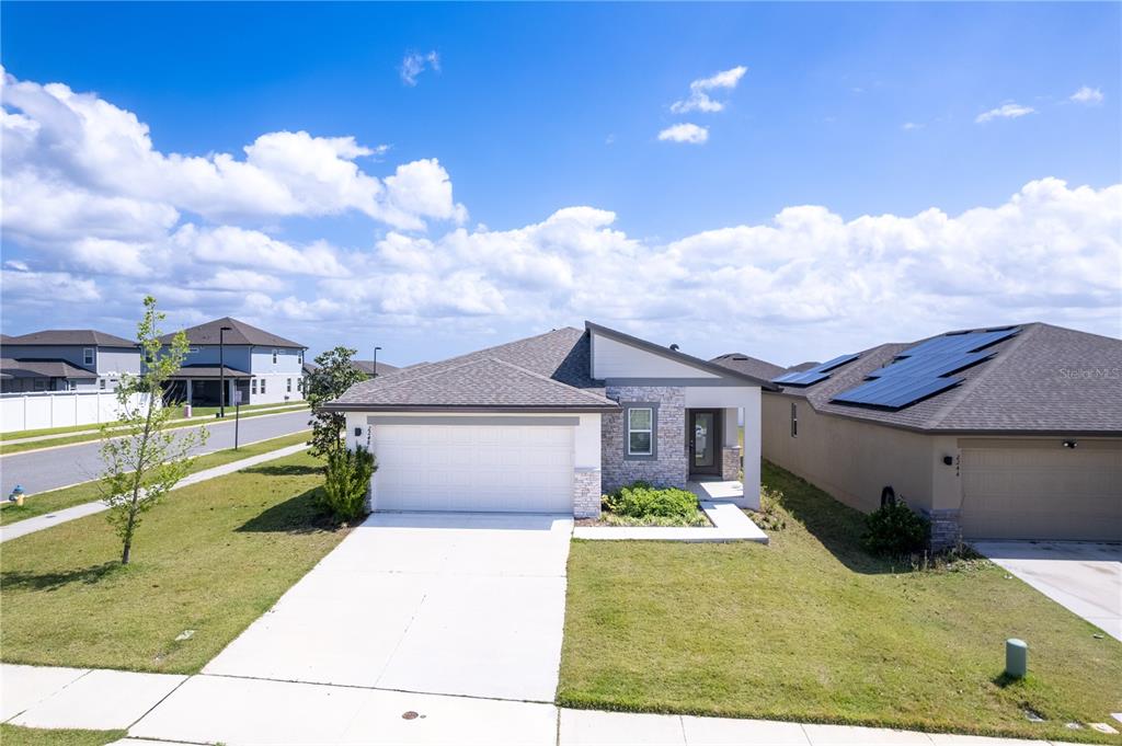 2248 Crossbow Street Minneola, FL 34715 - Photo 1 of 33 a front view of a house with a yard