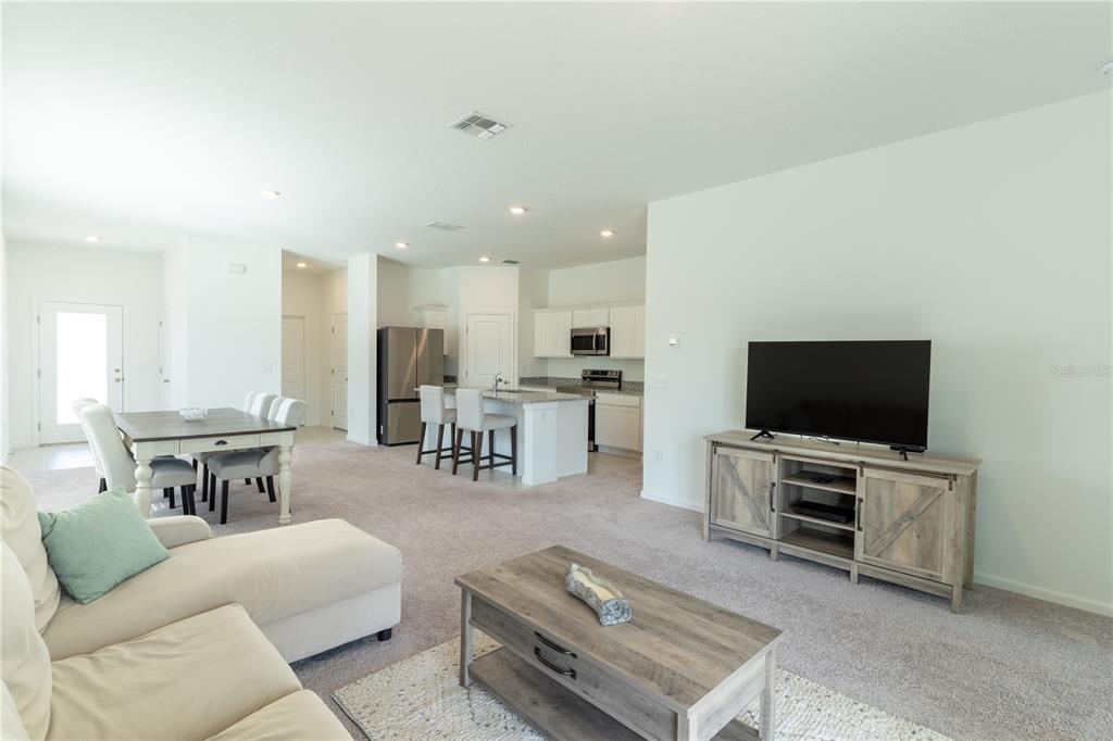 2248 Crossbow Street Minneola, FL 34715 - Photo 12 of 33 a living room with furniture and a flat screen tv