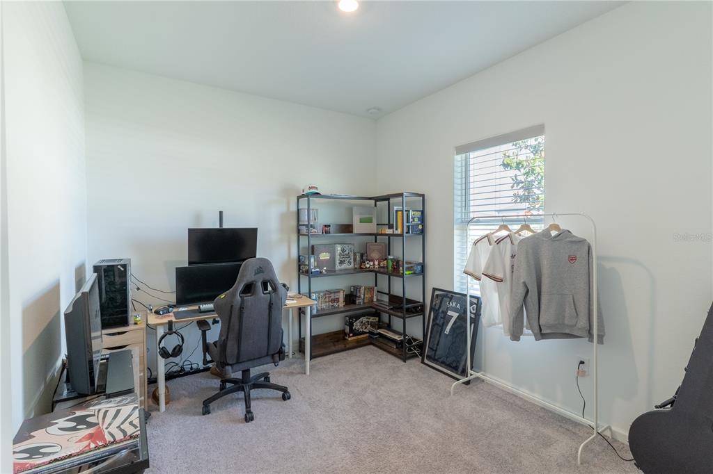 2248 Crossbow Street Minneola, FL 34715 - Photo 18 of 33 a view of a workspace with furniture and a window