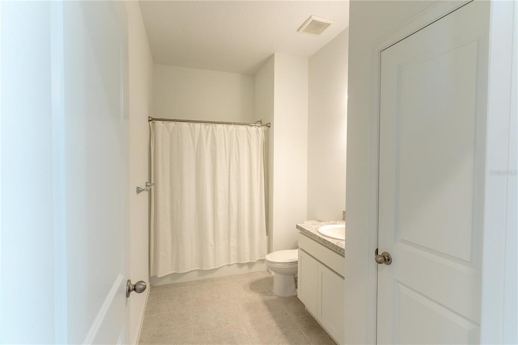2248 Crossbow Street Minneola, FL 34715 - Photo 22 of 33 a bathroom with a sink a toilet and shower