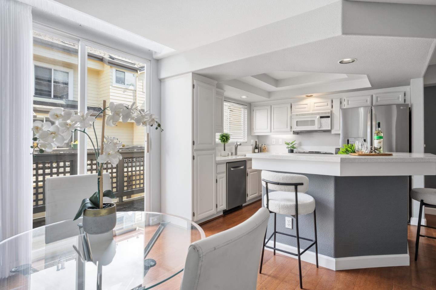 71 Patrick Way Half Moon Bay, CA 94019 - Photo 11 of 37 a kitchen with a table chairs refrigerator and cabinets