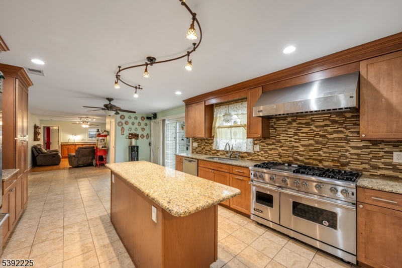 255 Knoll Road Lake Hiawatha, NJ 07034 - Photo 11 of 32 a large kitchen with stainless steel appliances granite countertop a stove and cabinets