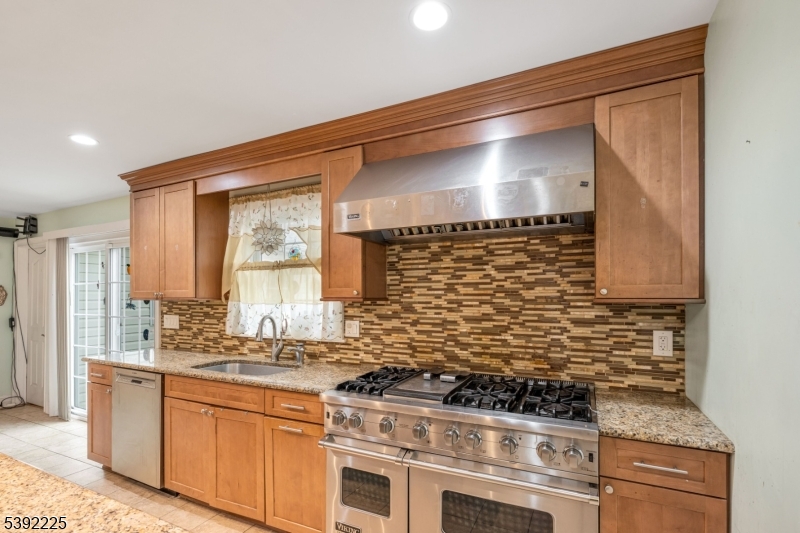 255 Knoll Road Lake Hiawatha, NJ 07034 - Photo 12 of 32 a kitchen with stainless steel appliances granite countertop a stove and a sink