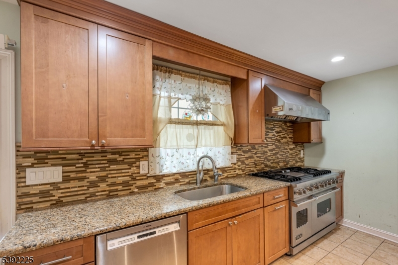 255 Knoll Road Lake Hiawatha, NJ 07034 - Photo 13 of 32 a kitchen with stainless steel appliances granite countertop a sink a stove and a microwave