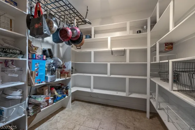 a kitchen area with lots of different colored cloths