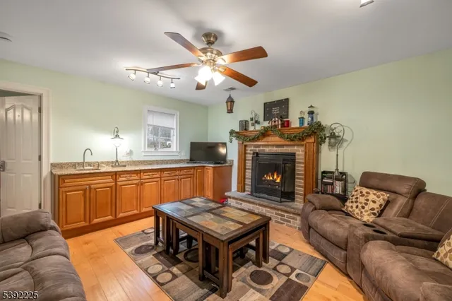 a living room with furniture a dining table and a fireplace