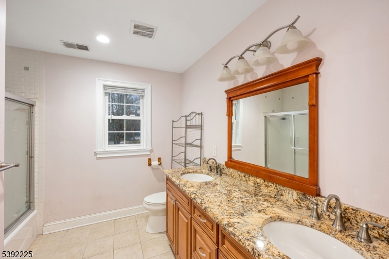 255 Knoll Road Lake Hiawatha, NJ 07034 - Photo 21 of 32 a bathroom with a granite countertop sink toilet and shower