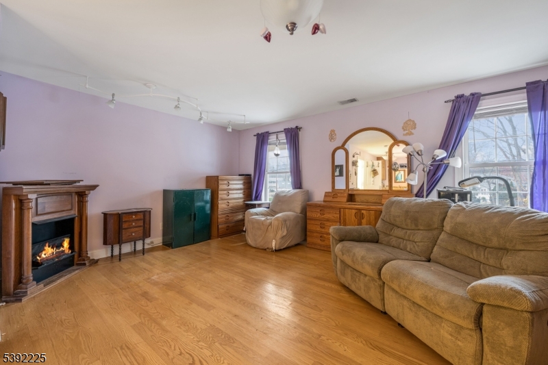 255 Knoll Road Lake Hiawatha, NJ 07034 - Photo 26 of 32 a living room with furniture and a fireplace