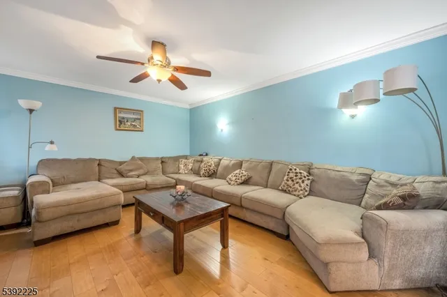 a living room with furniture and a ceiling fan