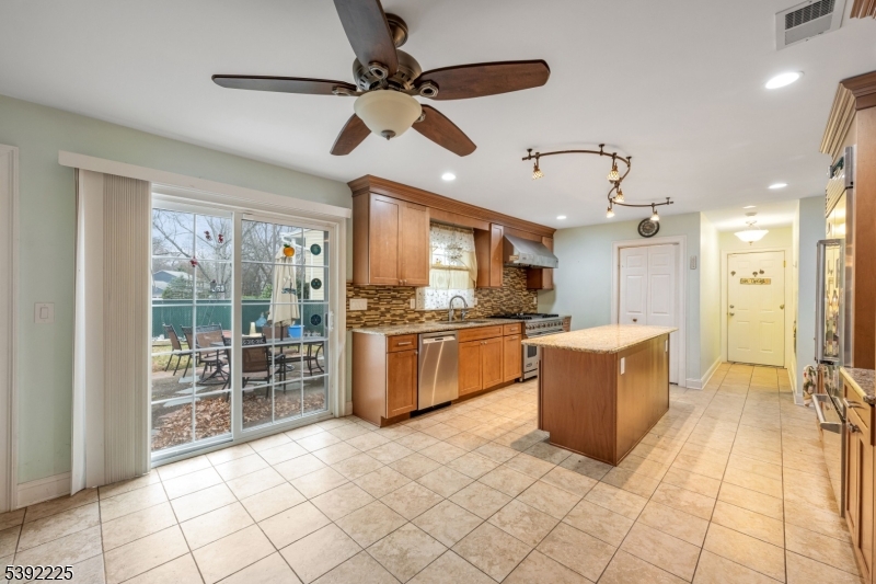 255 Knoll Road Lake Hiawatha, NJ 07034 - Photo 9 of 32 a large kitchen with cabinets and stainless steel appliances