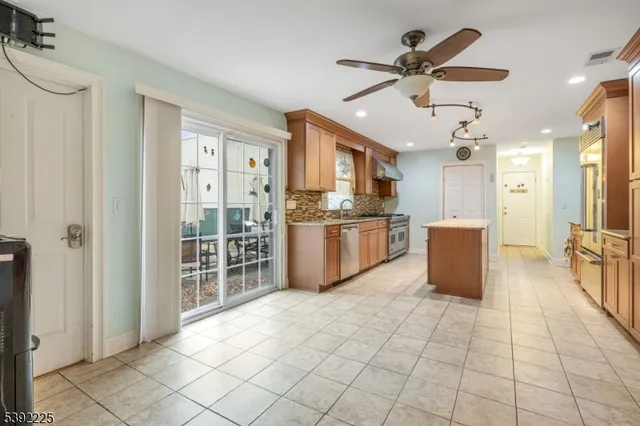a large kitchen with cabinets and stainless steel appliances