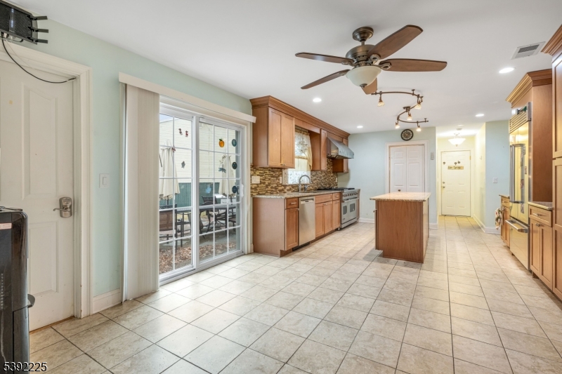 255 Knoll Road Lake Hiawatha, NJ 07034 - Photo 10 of 32 a large kitchen with cabinets and stainless steel appliances