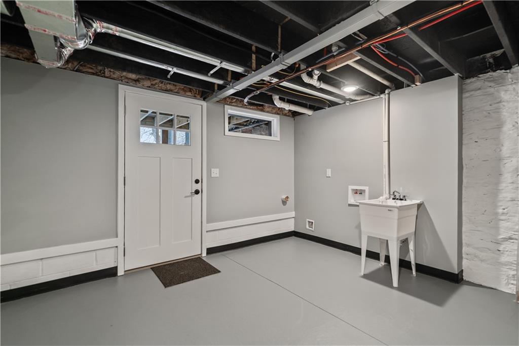 111 Hemlock Street Pittsburgh, PA 15212 - Photo 41 of 50 The lower level is pristine and easily ready to be finished. Everything is new. New lower level concrete floor. New sewer line. New plubing. New 200 AMP panel. Eletrical and gas is run for an additional laundry space. Step outside to your lower level concrete patio, fenced-in backyard and two car parking area!