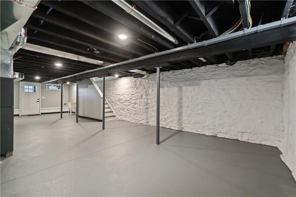 111 Hemlock Street Pittsburgh, PA 15212 - Photo 42 of 50 The lower level is pristine and easily ready to be finished. Everything is new. New lower level concrete floor. New sewer line. New plubing. New 200 AMP panel. Eletrical and gas is run for an additional laundry space. Step outside to your lower level concrete patio, fenced-in backyard and two car parking area!