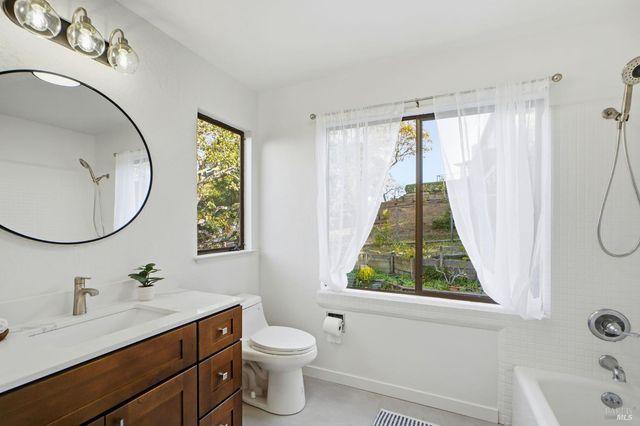 a bathroom with a shower curtain and a large window