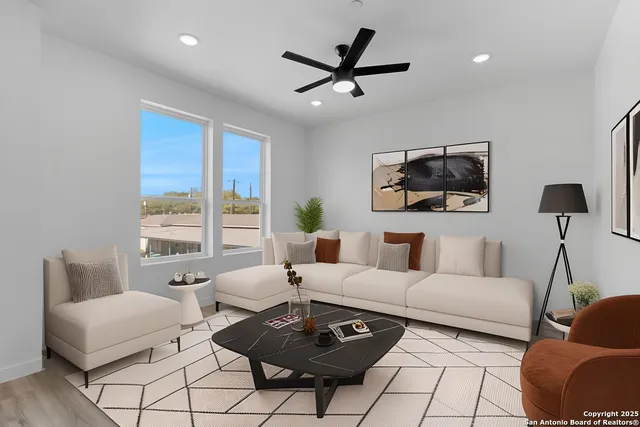 an empty room with a window and a ceiling fan