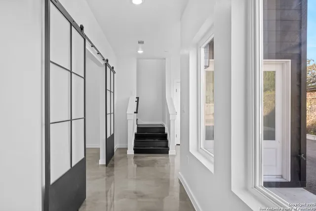 a view of a hallway with a white walls