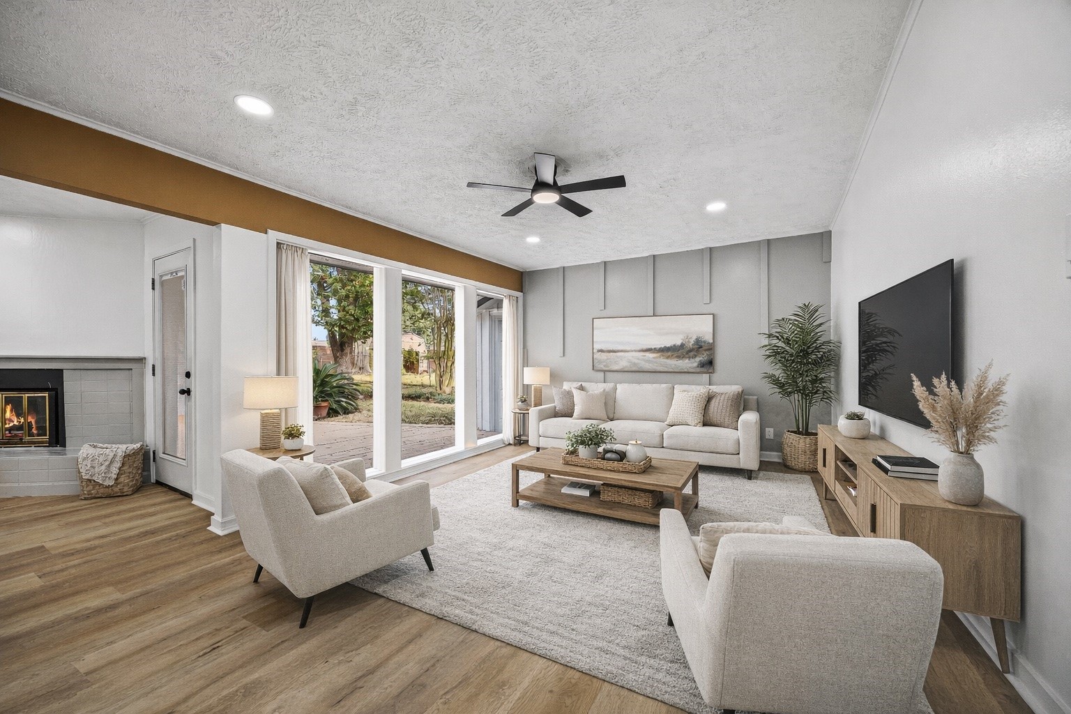 a living room with furniture ceiling fan and a flat screen tv