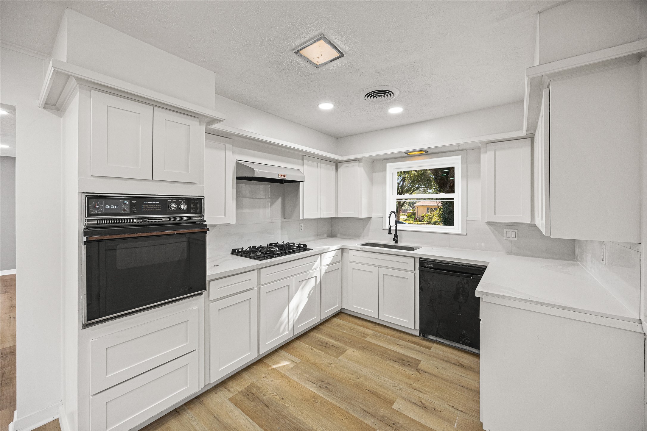 10259 Old Orchard Road La Porte, TX 77571 - Photo 12 of 23 a kitchen with stainless steel appliances granite countertop a stove a sink and a refrigerator