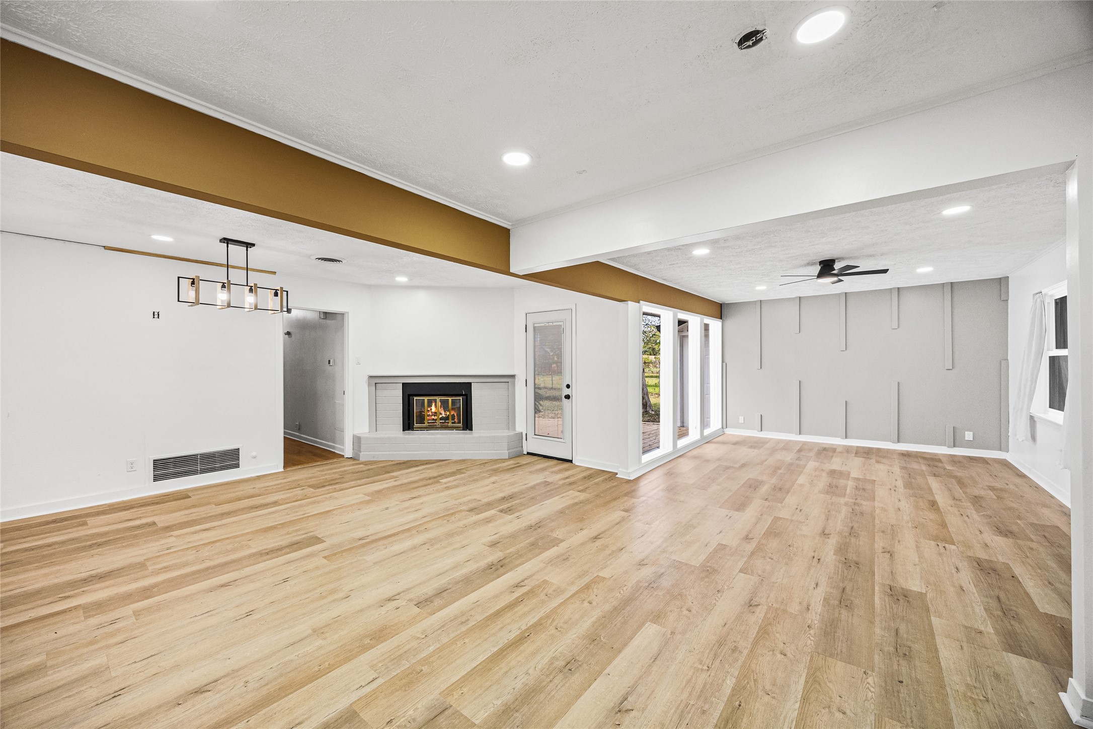 10259 Old Orchard Road La Porte, TX 77571 - Photo 13 of 23 a view of empty room with wooden floor and fireplace