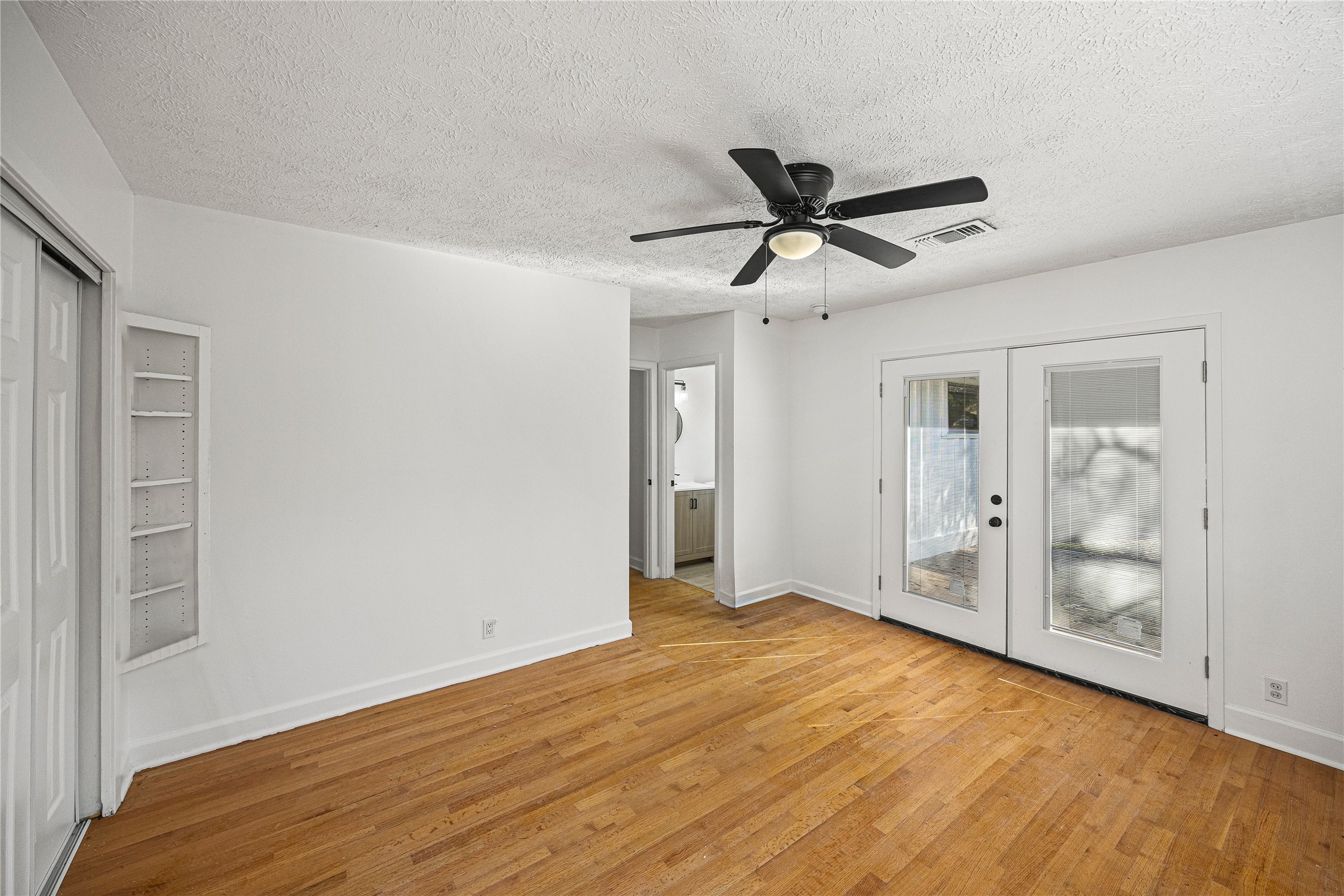 10259 Old Orchard Road La Porte, TX 77571 - Photo 16 of 23 a view of empty room with wooden floor and fan