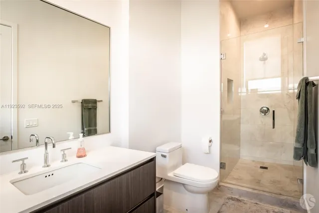 a bathroom with a sink toilet and shower