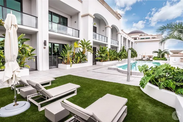 a view of a patio with couches table and chairs and potted plants