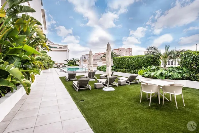 a view of a patio with a table and chairs