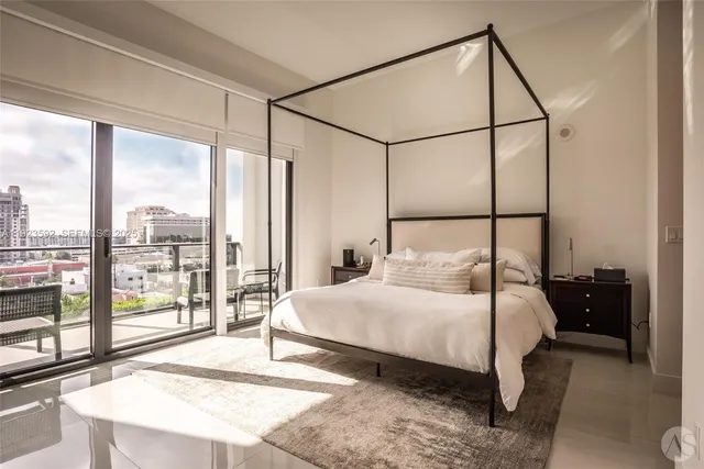 a bedroom with a bed and large window